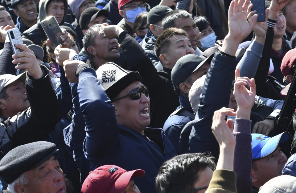 People protest during a rally on the central square in Bishkek, Kyrgyzstan, Wednesday, Oct. 7, 2020. Officials in Kyrgyzstan have nullified the results of a weekend parliamentary election after mass protests erupted in the capital of Bishkek and other cities, with opposition supporters seizing government buildings and demanding a new vote. (AP Photo/Vladimir Voronin)