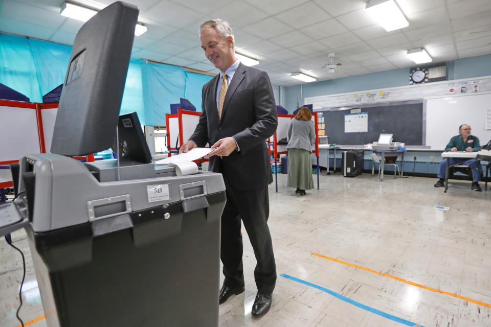 Mayor Jon Mitchell casts his ballot at the Hathaway School polling station in New Bedford. Mitchell won a rematch over Richard Tyson Moultrie, 5,272 to 2,719.