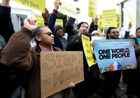 People hold protest signs after attending Friday prayers, to show solidarity with the Muslim community, at the Islamic Center of Southern California in Los Angeles, California, U.S. February 3, 2017. REUTERS/Kevork Djansezian