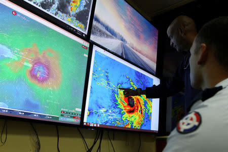 Members of the Emergency Operations Committee (COE) monitor the trajectory of Hurricane Maria in Santo Domingo, Dominican Republic, September 19, 2017. REUTERS/Ricardo Rojas