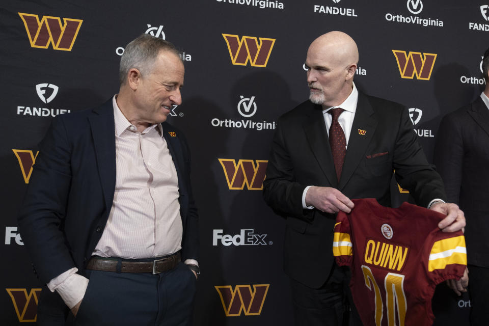 Washington Commanders new head coach Dan Quinn, right, is presented with a jersey by Commanders managing partner Josh Harris, left, during an NFL football news conference at Commanders Park in Ashburn, Va., Monday, Feb. 5, 2024. (AP Photo/Manuel Balce Ceneta)