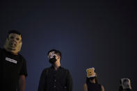 Protesters wear masks during a protest in Hong Kong, Friday, Oct. 18, 2019. Hong Kong pro-democracy protesters are donning cartoon/superhero masks as they formed a human chain across the semiautonomous Chinese city, in defiance of a government ban on face coverings. (AP Photo/Felipe Dana)