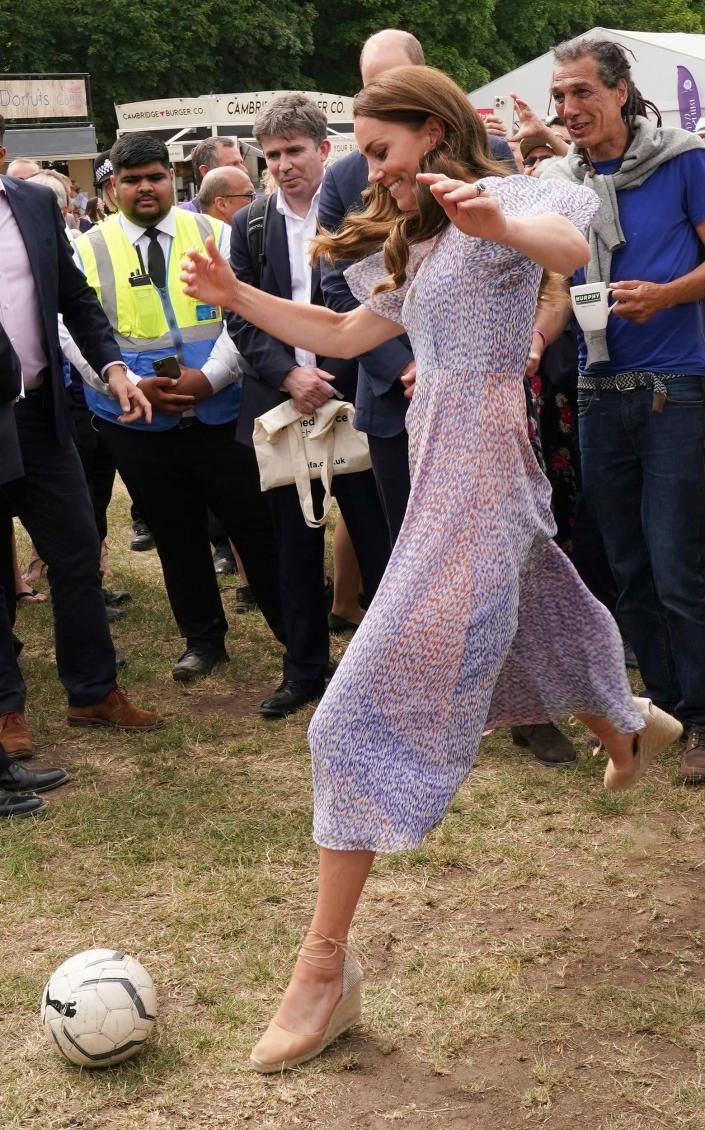 Britain's Kate, Duchess of Cambridge, plays soccer during a visit to Cambridgeshire County Day - Paul Edwards 