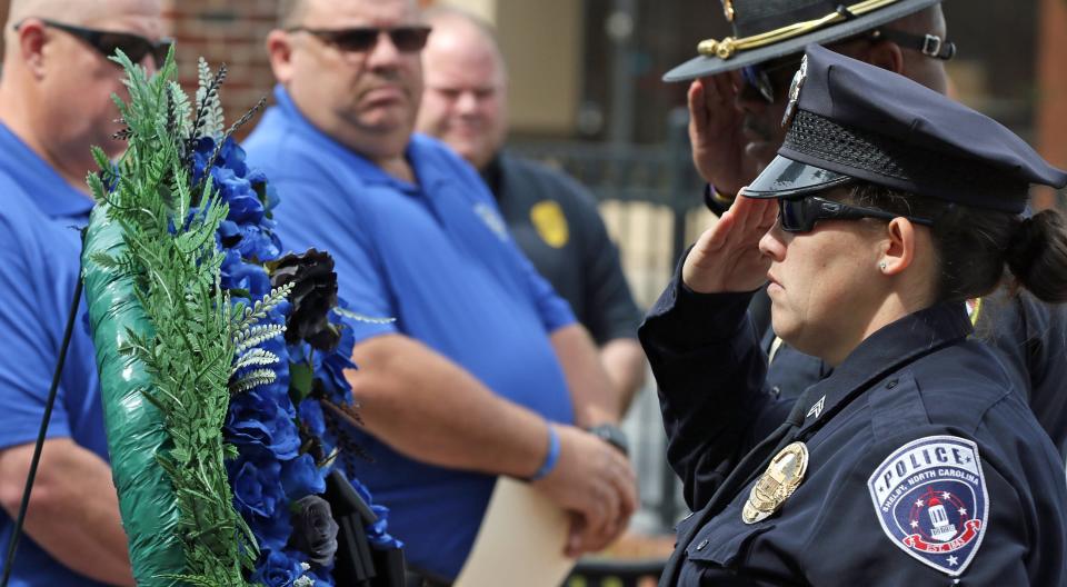Shelby Officer Danielle Brown salutes during a wreath laying ceremony held Friday morning, May 5, 2023, at the Fallen Heroes Memorial in Shelby.