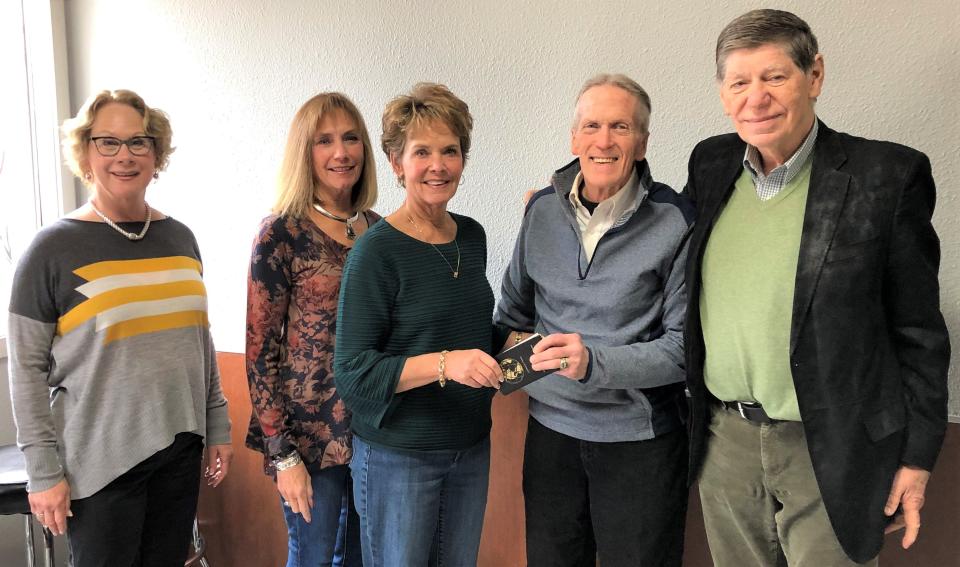 FILE - Pictured here in 2019, Helen Gajdys Reis & Lester Reis Endowment Fund board members present a check to Woody Shulander of Peter's Pantry. Pictured, from left: Mary Reis, Kathy Hanke, Gloria Theis, Shulander and George Reis.