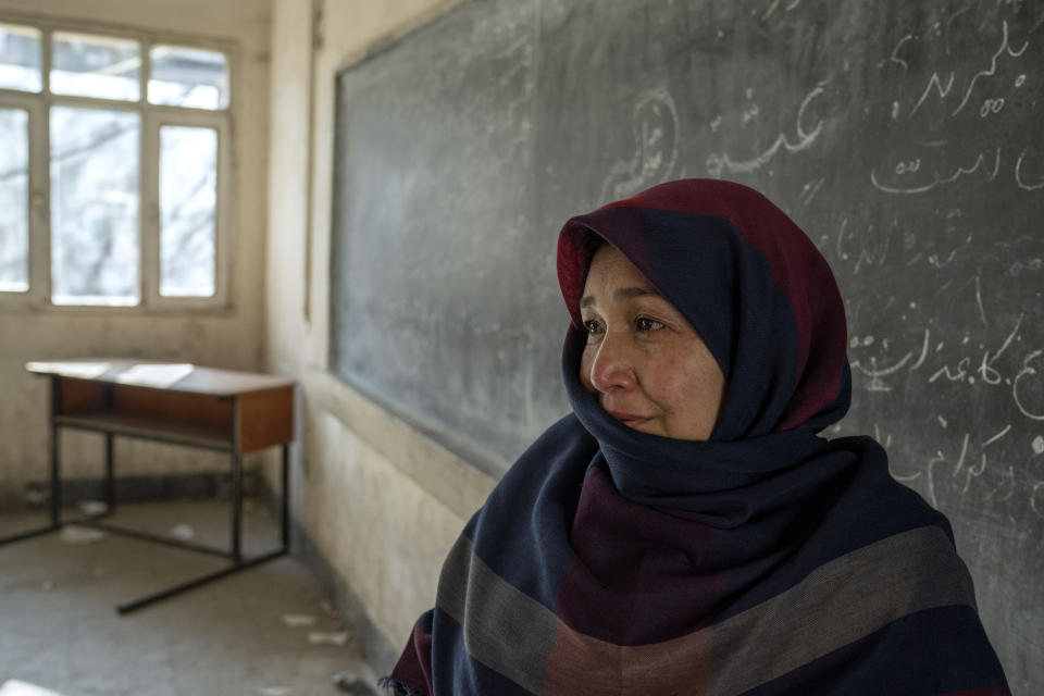 Amanah Nashenas, 45-year-old an Afghan teacher, cries during an interview with Associated Press about the state of education, in a school in Kabul, Afghanistan, Thursday, Dec. 22, 2022. The country's Taliban rulers earlier this week ordered women nationwide to stop attending private and public universities effective immediately and until further notice. They have banned girls from middle school and high school, barred women from most fields of employment and ordered them to wear head-to-toe clothing in public. Women are also banned from parks and gyms.(AP Photo/Ebrahim Noroozi)
