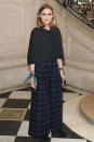<p><strong>26 September</strong> Olivia Palermo wore a checked skirt with a black cape for the occasion.</p>