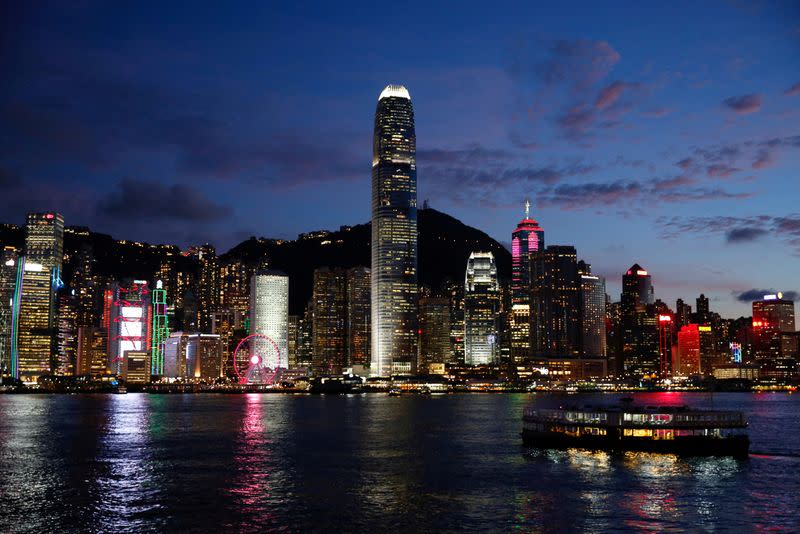 FILE PHOTO: A ferry boat crosses Victoria Harbour during sunset in Hong Kong