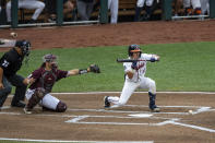 Virginia catcher Logan Michaels (12) SAC bunts the ball advancing Jake Gelof, not pictured, to second base against Mississippi State in the second inning during a baseball game in the College World Series Tuesday, June 22, 2021, at TD Ameritrade Park in Omaha, Neb. (AP Photo/John Peterson)