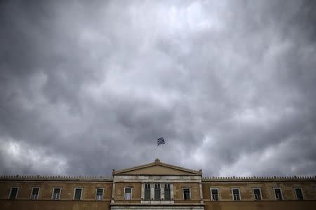 A Greek national flag flutters atop the parliament building in Athens, Greece, October 30, 2015. REUTERS/Alkis Konstantinidis
