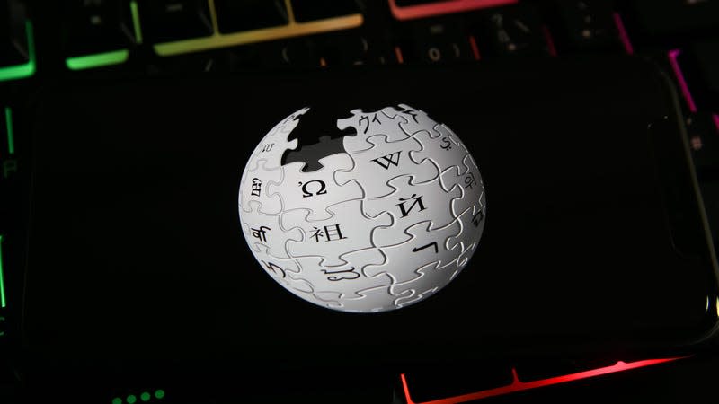 A phone with the Wikipedia globe logo on top of the LED keyboard keys.