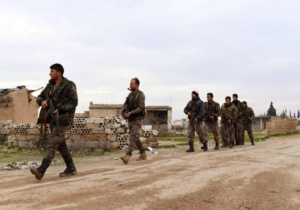 In this photo released Wednesday Feb. 5, 2020 by the Syrian official news agency SANA, shows Syrian government forces patrolling the village of Tel-Toukan, in Idlib province, northwest Syria. On Thursday, State media and opposition activists said Turkey has sent more reinforcements into northwestern Syria, setting up new positions in an attempt to stop a government offensive on the last rebel stronghold in the war-torn country. (SANA via AP)