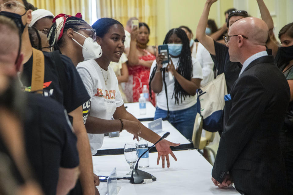 Demonstrators confront Gene Davis, vice chairman of the UNC-Chapel Hill Board of Trustees, after the board voted to approve tenure for distinguished journalist Nikole Hannah-Jones Wednesday, June 30, 2021 at Carolina Inn in Chapel Hill, N.C. (Travis Long/The News & Observer via AP)