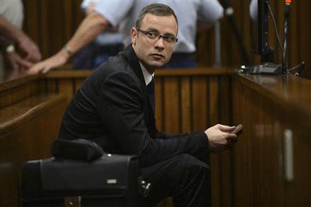 Olympic and Paralympic track star Oscar Pistorius sits in the dock during court proceedings at the North Gauteng High Court in Pretoria March 14, 2014. REUTERS/Phill Magakoe/Pool