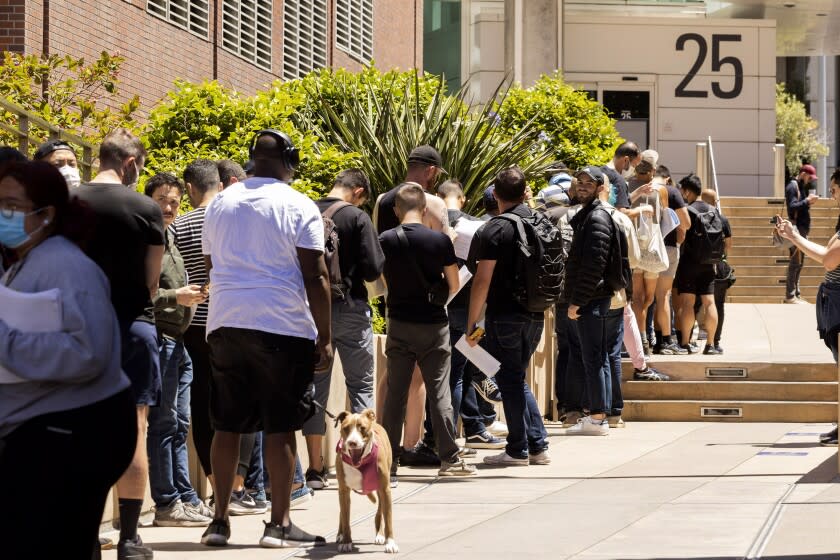 People stand in long lines to receive the monkeypox vaccine at San Francisco General Hospital in San Francisco, Tuesday, July 12, 2022. (Jessica Christian/San Francisco Chronicle via AP)