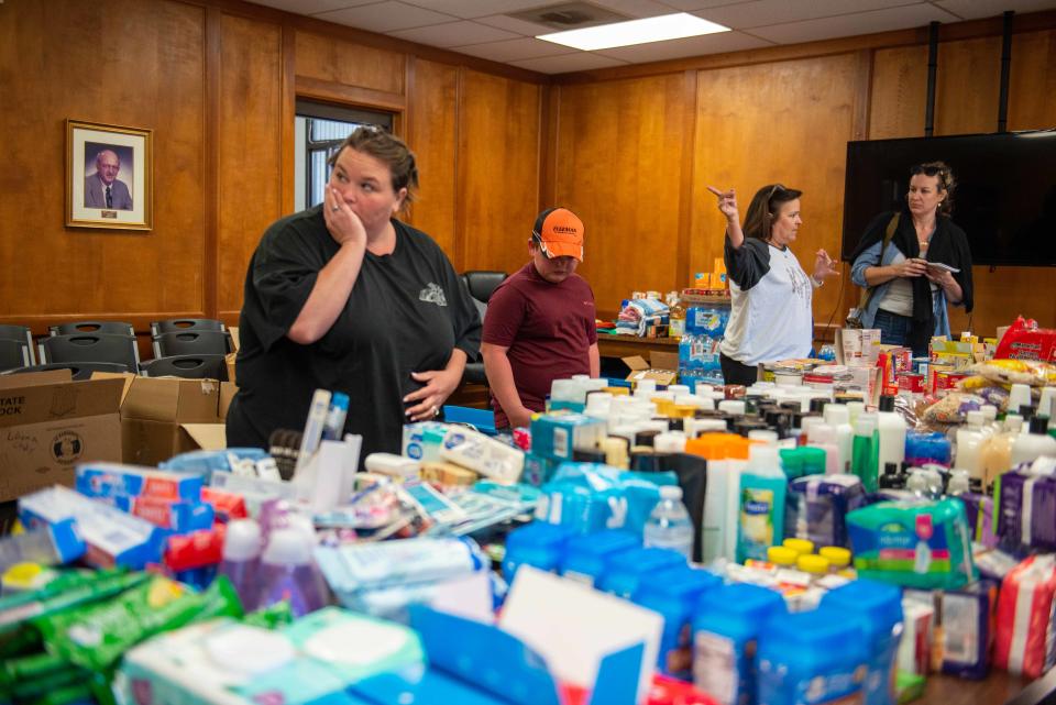 People browse through a donated goods inside the Adamsville City Hall on Sunday, Apr. 2, 2023. People around McNairy County have pitched in supplies for those affected by the series of storms that totaled 72 homes and claimed 9 casualties. 