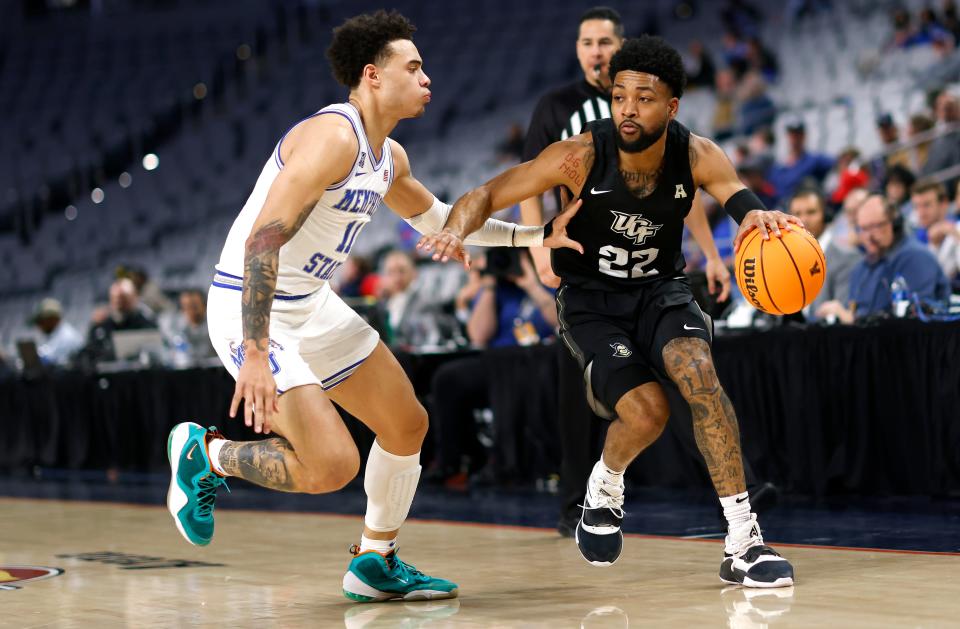 FORT WORTH, TX - MARCH 11: Darin Green Jr. #22 of the UCF Knights handles the ball as Lester Quinones #11 of the Memphis Tigers defends in the first half of the American Athletic Conference Mens Basketball Tournament Quarterfinals at Dickies Arena on March 11, 2022 in Fort Worth, Texas. (Photo by Ron Jenkins/Getty Images)