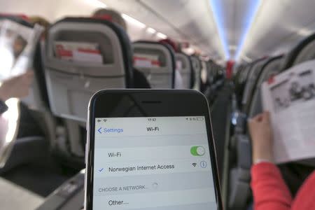 A mobile phone is connected to Wi-Fi network on board a Norwegian Airways Boeing 737-800 at Berlin Schoenefeld Airport in this April 2, 2015 file photo. REUTERS/Pawel Kopczynski