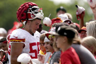 Kansas City Chiefs defensive end George Karlaftis signs autographs at the Kansas City Chiefs' NFL football training camp Sunday, Aug. 7, 2022, in St. Joseph, Mo. (AP Photo/Charlie Riedel)