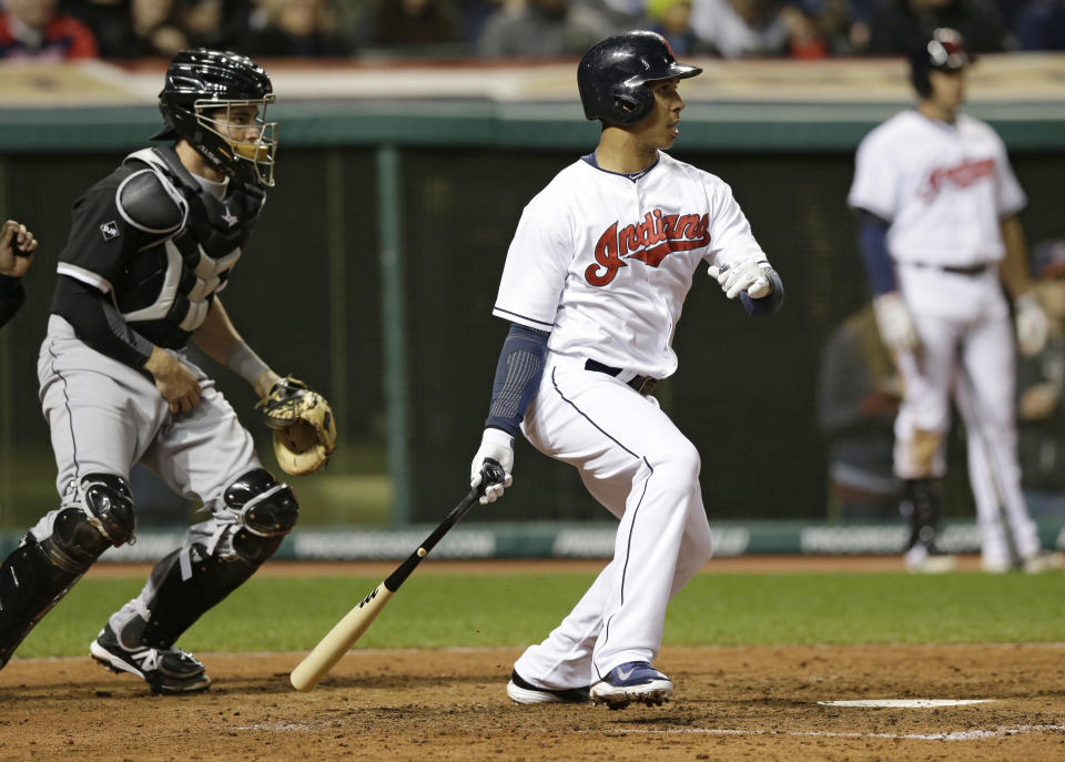Cleveland Indians' Michael Brantley, front right, hits a two-RBI single off Chicago White Sox relief pitcher Maikel Cleto in the sixth inning of a baseball game on Friday, May 2, 2014, in Cleveland. Indians' Nick Swisher and Carlos Santana scored. White Sox catcher Adrian Nieto, left, watches. (AP Photo/Tony Dejak)