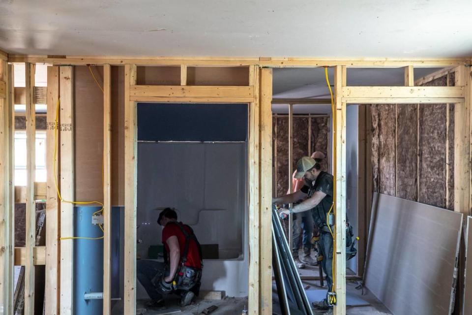 Crews work to install drywall at a home in Perry County, Ky., on Tuesday, July 11, 2023, that is being built by the Hazard-based Housing Development Alliance. The organization has so far completed nine homes, is working on a dozen more and completed about 30 repair jobs.