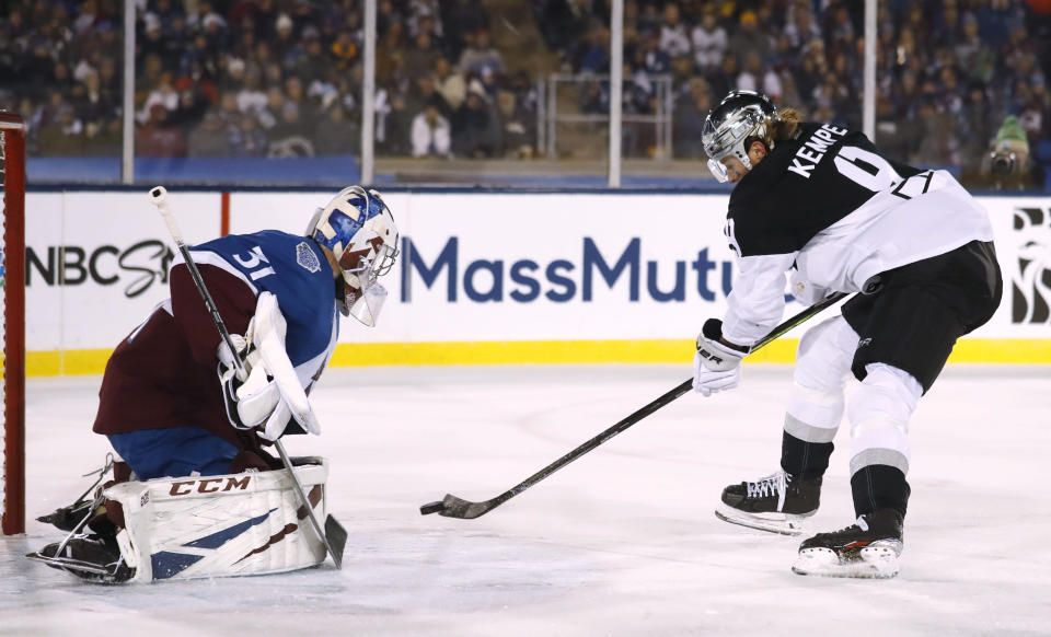 Los Angeles Kings center Adrian Kempe, right, puts a shot on Colorado Avalanche goaltender Philipp Grubauer during the first period of an NHL hockey game Saturday, Feb. 15, 2020, at Air Force Academy, Colo. (AP Photo/David Zalubowski)