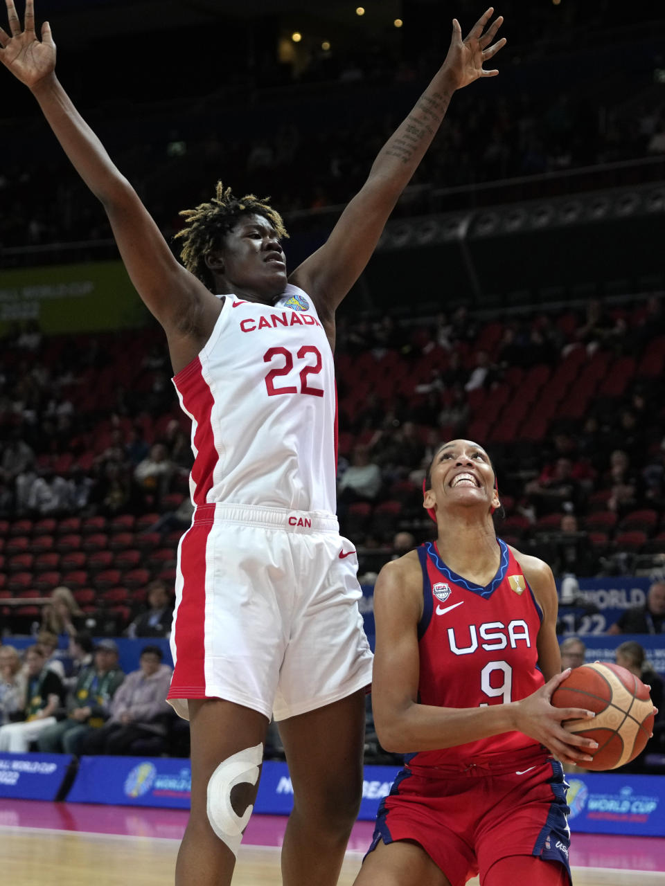 Canada's Phillipina Kyei, left, blocks United States' A'ja Wilson during their semifinal game at the women's Basketball World Cup in Sydney, Australia, Friday, Sept. 30, 2022. (AP Photo/Rick Rycroft)