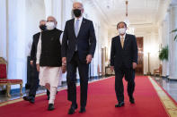 President Joe Biden walks to the Quad summit with, from left, Australian Prime Minister Scott Morrison, Indian Prime Minister Narendra Modi, and Japanese Prime Minister Yoshihide Suga, in the East Room of the White House, Friday, Sept. 24, 2021, in Washington. (AP Photo/Evan Vucci)