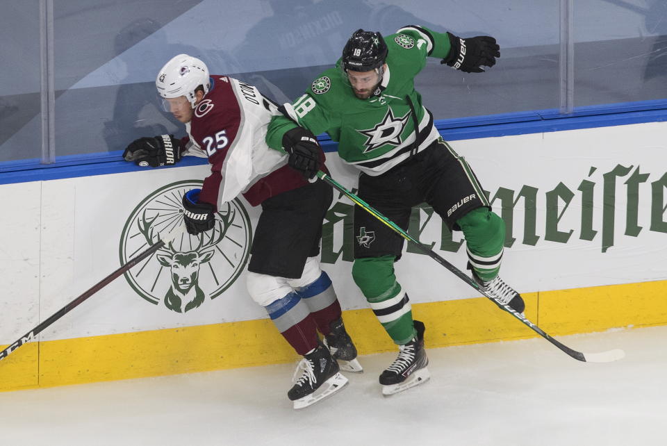 Dallas Stars' Jason Dickinson (18) checks Colorado Avalanche's Logan O'Connor (25) during the first period of an NHL hockey second-round playoff series, Sunday, Aug. 30, 2020, in Edmonton, Alberta. (Jason Franson/The Canadian Press via AP)