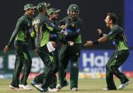 Pakistan's Ahmed Shehzad (C) celebrates with his teammates Imad Wasim (2nd L), captain Azhar Ali (L), Sarfraz Ahmed (2nd R) and Yasir Shah (R) after taking the catch to dismiss Sri Lanka's Lahiru Thirimanne (not pictured) during their fourth One Day International cricket match in Colombo July 22,2015. REUTERS/Dinuka Liyanawatte