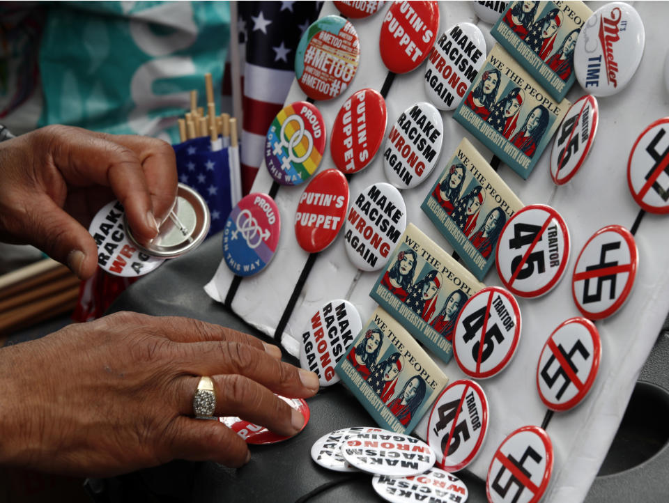 <p>Buttons are for sale at a rally in Freedom Plaza, on the one year anniversary of Charlottesville’s Unite the Right rally, Sunday, Aug. 12, 2018, in Washington. (Photo: Alex Brandon/AP) </p>