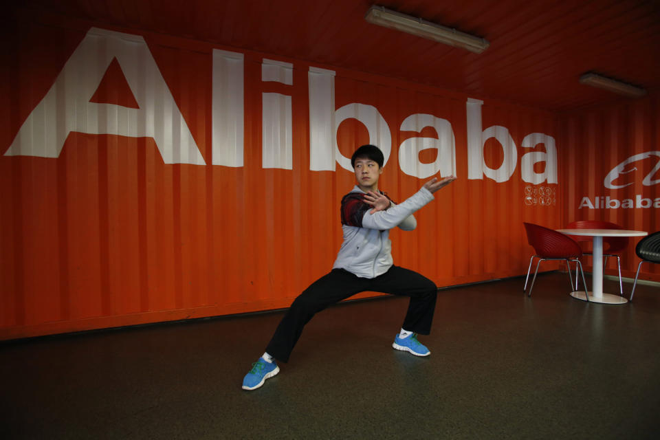 In this photo taken Tuesday March 26, 2013 and made available March 11, 2014, a worker performs shadow boxing during an open day at the Alibaba Group office in Hangzhou in east China's Zhejiang province. Ten companies including Internet giants Alibaba and Tencent have been picked to invest in China's first five privately owned banks, the industry's chief regulator said Tuesday, March 11, 2014. (AP Photo) CHINA OUT