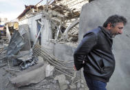 A man walks past a shop damaged by shelling by Azerbaijan's artillery at a market in Stepanakert, the separatist region of Nagorno-Karabakh, Saturday, Oct. 31, 2020. Nagorno-Karabakh authorities said Azerbaijani military targeted a street market in Stepanakert and residential areas of Shushi on Saturday in violation of a mutual pledge not to target residential areas made after talks in Geneva. (AP Photo)