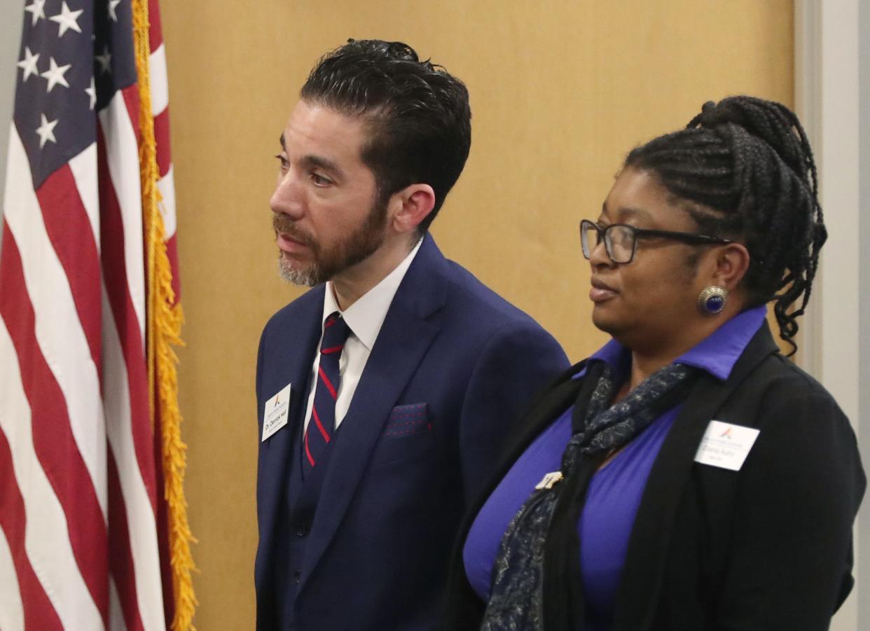 Derrick Hall, newly elected Akron school board president, and Diana Autry, newly elected board vice president, are sworn in during the Akron school board meeting Monday.