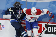 Winnipeg Jets' Sami Niku (8) loses his helmet after a collision with Montreal Canadiens' Corey Perry (94) during the first period of an NHL hockey game Saturday, Feb. 27, 2021, in Winnipeg, Manitoba. (John Woods/The Canadian Press via AP)