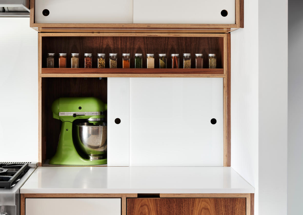  A sliding appliance garage in a kitchen. 