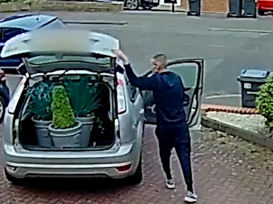 CCTV of a male stealing three plants from a drive in Harborne, Birmingham, before driving off in a silver Ford Focus.  See SWNS story SWMDplants.  Police  want to speak to him after three plant pots were stolen from a drive on Park Hill Road, shortly before 9pm on Sunday 26 July.  He left in a Ford Focus which is believed to be on false plates.