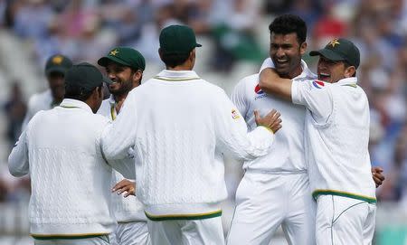 Britain Cricket - England v Pakistan - Third Test - Edgbaston - 3/8/16 Pakistan's Sohail Khan celebrates with team mates after taking the wicket of England's Joe Root (not pictured) Action Images via Reuters / Paul Childs