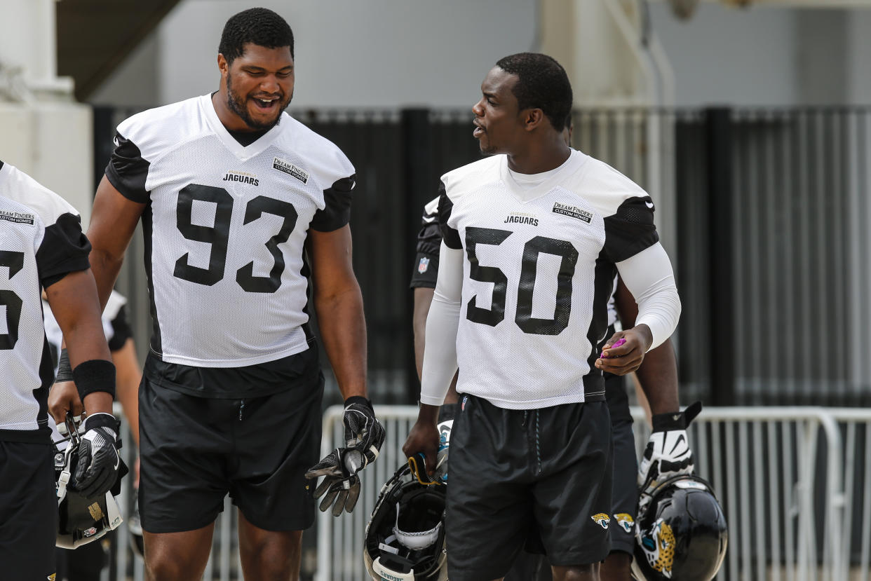 Jacksonville Jaguars defensive lineman Calais Campbell (93) and linebacker Telvin Smith (50) walk out to the practice field on June 14, 2018. (David Rosenblum/Getty Images)