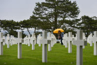 <p>Visitors view the graves of fallen soldiers at the Normandy American Cemetery. (Photo: Artur Widak/NurPhoto via Getty Images) </p>