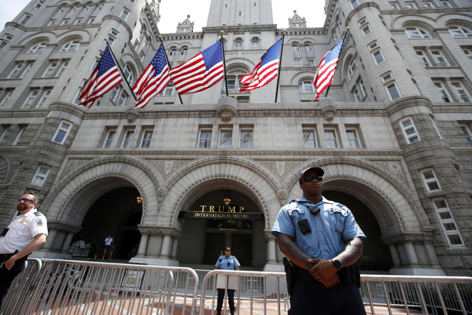 Law enforcement officers stand guard in front of the Trump Hotel in Washington. (AP Photo/Alex Brandon, File)