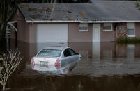 A partially submerged car and home are shown after Hurricane Ian caused widespread damage and flooding in Kissimmee, Florida, U.S., September 29, 2022. REUTERS/Joe Skipper