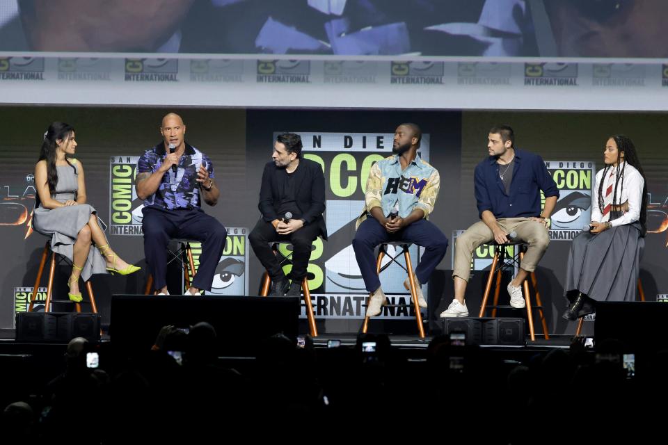 From left to right: Tiffany Smith, Dwayne Johnson, Jaume Collet-Serra, Aldis Hodge, Noah Centineo, and Quintessa Swindell on stage at the Warner Bros. panel promoting "Black Adam" at San Diego Comic-Con.