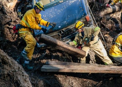 Rescue workers scour through cars for missing persons after a mudslide in Montecito, California, U.S. January 12, 2018. REUTERS/Kyle Grillot