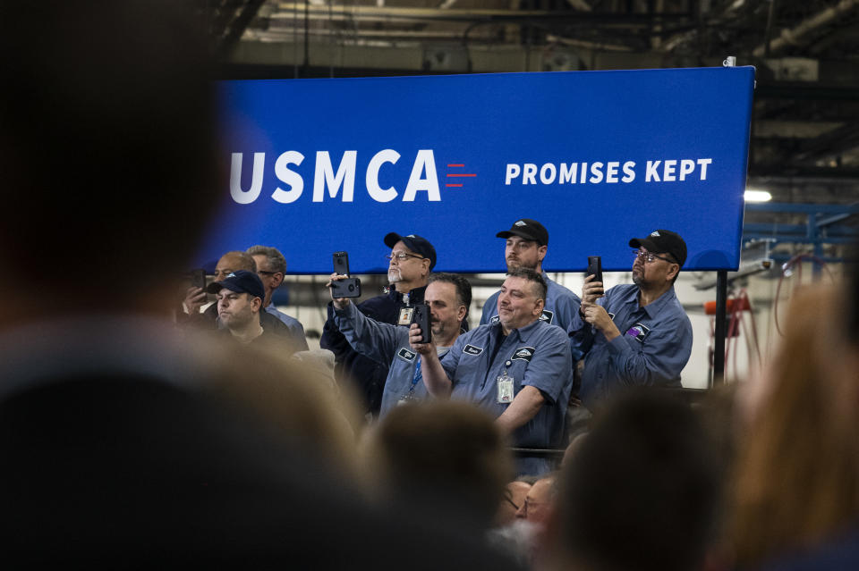 WARREN, MI - JANUARY 30: Employees record with their phones as President Donald Trump speaks during a visit to Dana Incorporated, an auto-manufacturing supplier, on January 30, 2020 in Warren, Michigan. During his speech Trump touted good job numbers and the strong performance of car companies in the state. (Photo by Brittany Greeson/Getty Images)