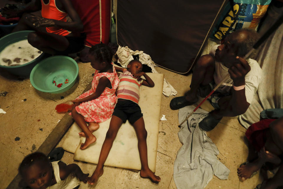 A boy lies on pieces of foam at a shelter for displaced Haitians, in Port-au-Prince, Haiti, Saturday, July 10, 2021, three days after Haitian President Jovenel Moise was assassinated in his home. The displaced Haitians were forced to flee their community where they had settled after the 2010 earthquake, after armed gangs set their homes on fire in late June. (AP Photo/Fernando Llano)