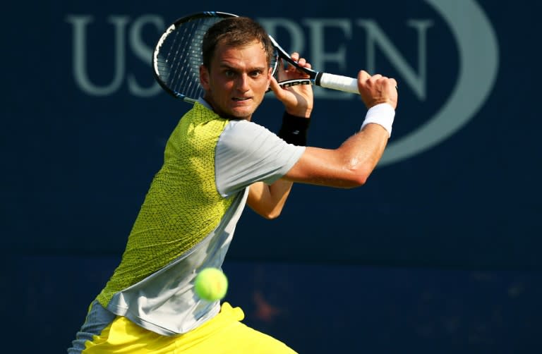 Aleksandr Nedovyesov returns a shot against Lleyton Hewitt during their US Open match at the USTA Billie Jean King National Tennis Center on September 1, 2015