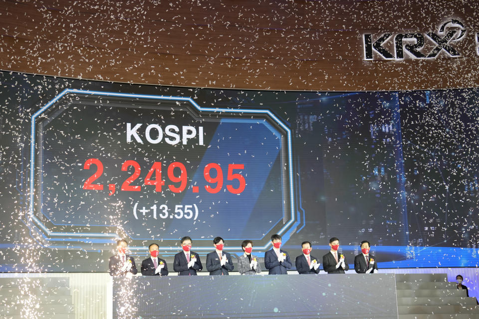 A huge screen shows the Korea Composite Stock Price Index (KOSPI) as participants applaud during the opening ceremony of the 2023 trading year at the Korea Exchange in Seoul, South Korea, Monday, Jan. 2, 2023. (AP Photo/Lee Jin-man)