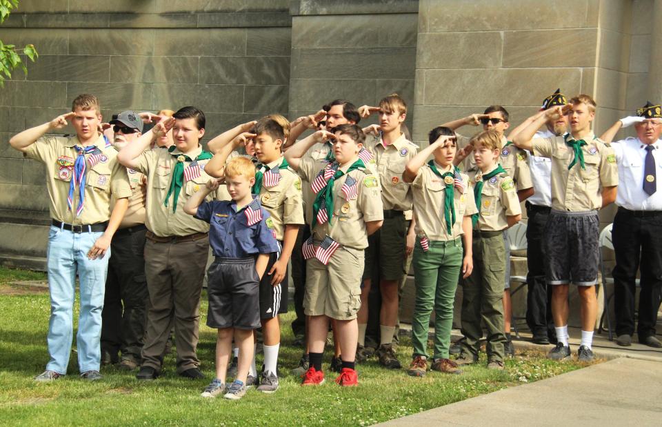 Members of the Boy Scouts Troop 76 recite the Pledge of Allegiance at the Memorial Day service at Southside Cemetery Monday.