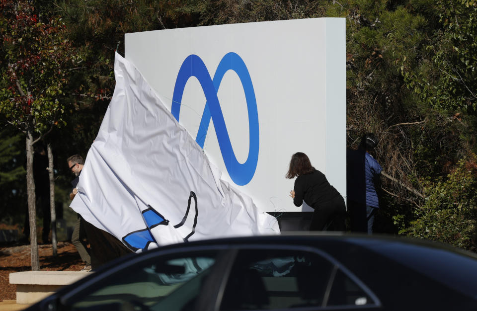 MENLO PARK, CALIFORNIA - OCTOBER 28: Facebook employees unveil a new logo and the name 'Meta' on the sign in front of Facebook headquarters on October 28, 2021 in Menlo Park, California. A new name and logo were unveiled at Facebook headquarters after a much anticipated name change for the social media platform. (Photo by Justin Sullivan/Getty Images)